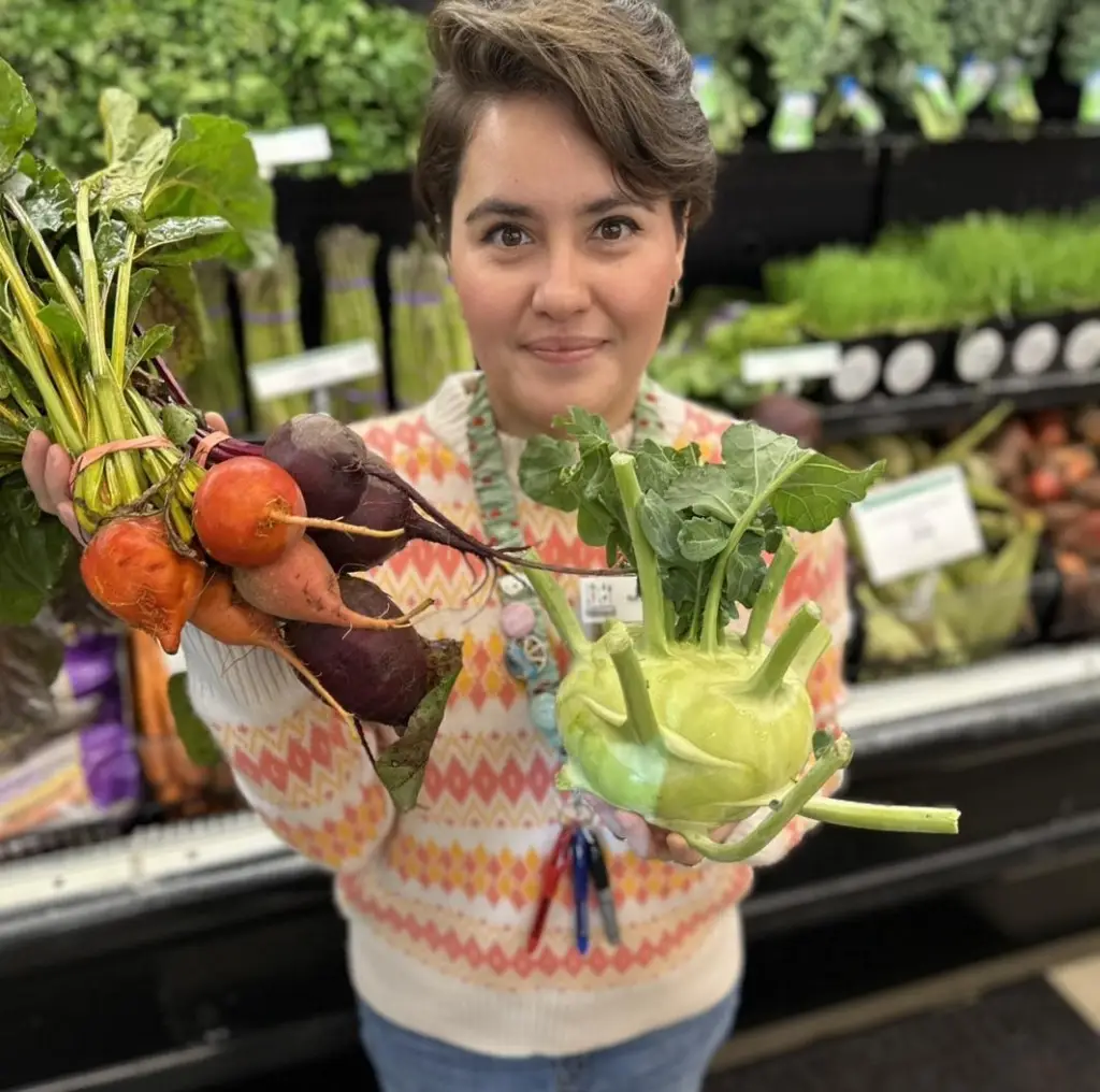 Holding fresh beets and kohlrabi in the Food Shed Co-op produce department